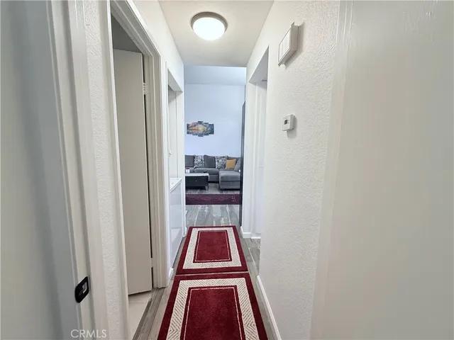 a view of a bedroom with wooden floor