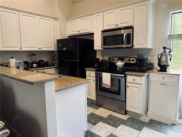 a kitchen with a sink and steel appliances