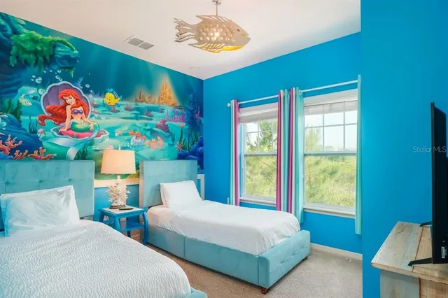 a bedroom with two beds and a window