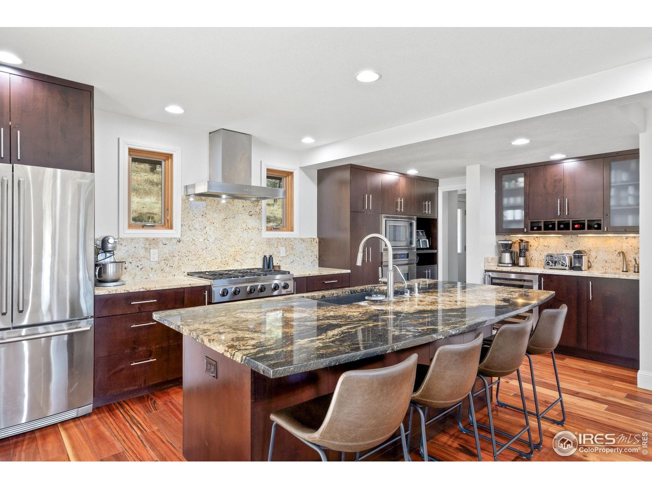 8543 Middle Fork Road Boulder, CO 80302 - Photo 17 of 48 a kitchen with kitchen island granite countertop a sink and refrigerator