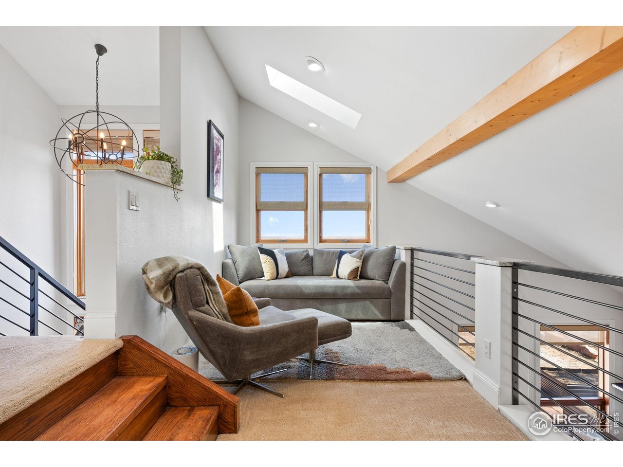 8543 Middle Fork Road Boulder, CO 80302 - Photo 25 of 48 a living room with furniture a chandelier and a dining table