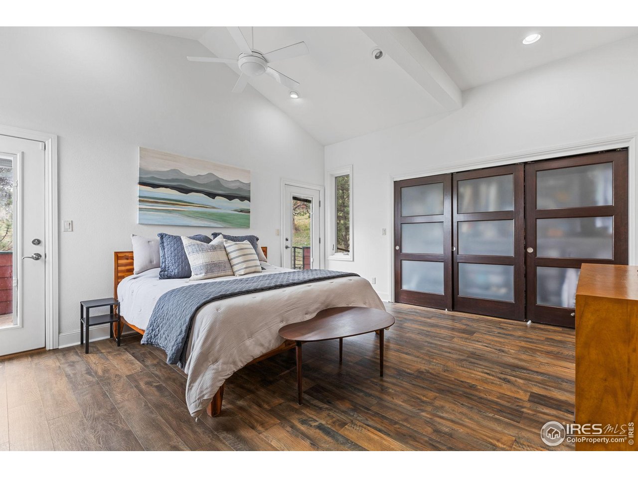 8543 Middle Fork Road Boulder, CO 80302 - Photo 27 of 48 a bedroom with a bed a table and wooden floor