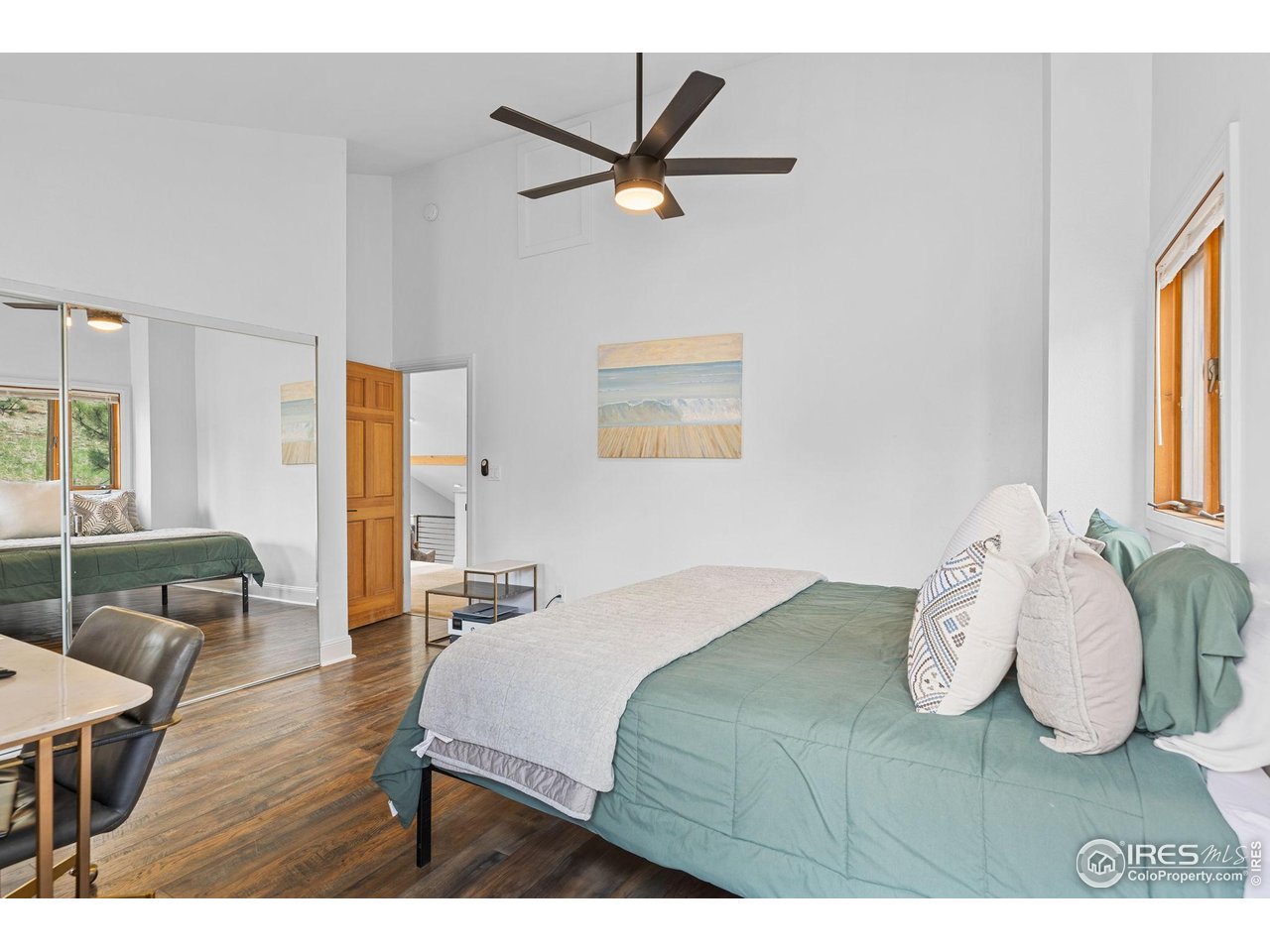 8543 Middle Fork Road Boulder, CO 80302 - Photo 37 of 48 a bedroom with a bed and window with wooden floor