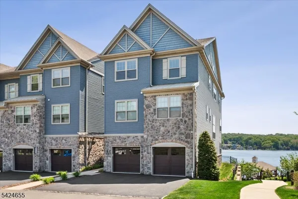 a front view of a house with a garden and plants