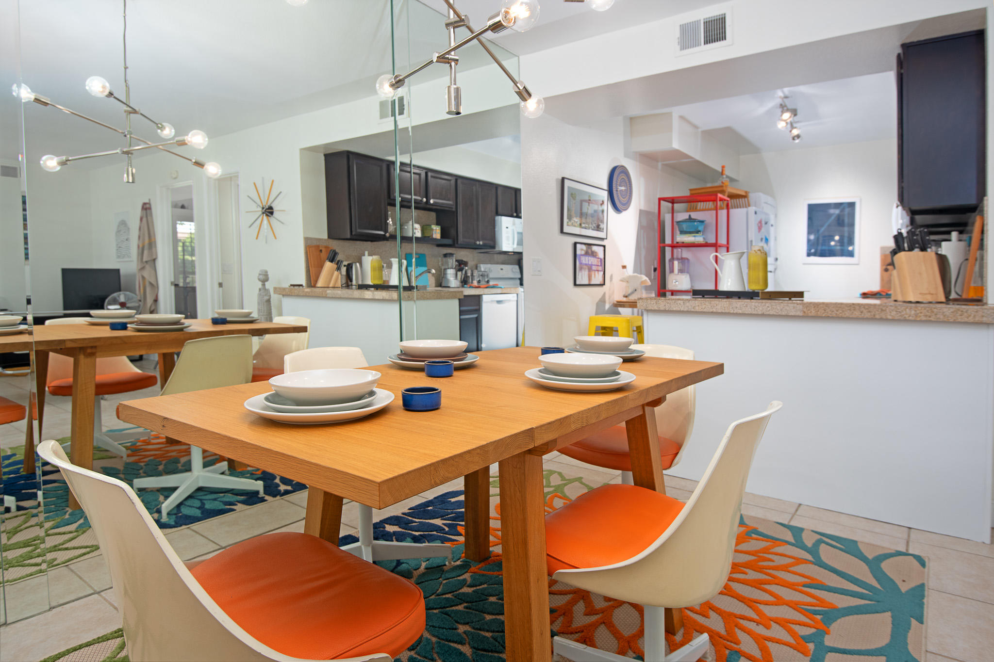 a dining room with stainless steel appliances granite countertop a dining table and chairs with wooden floor