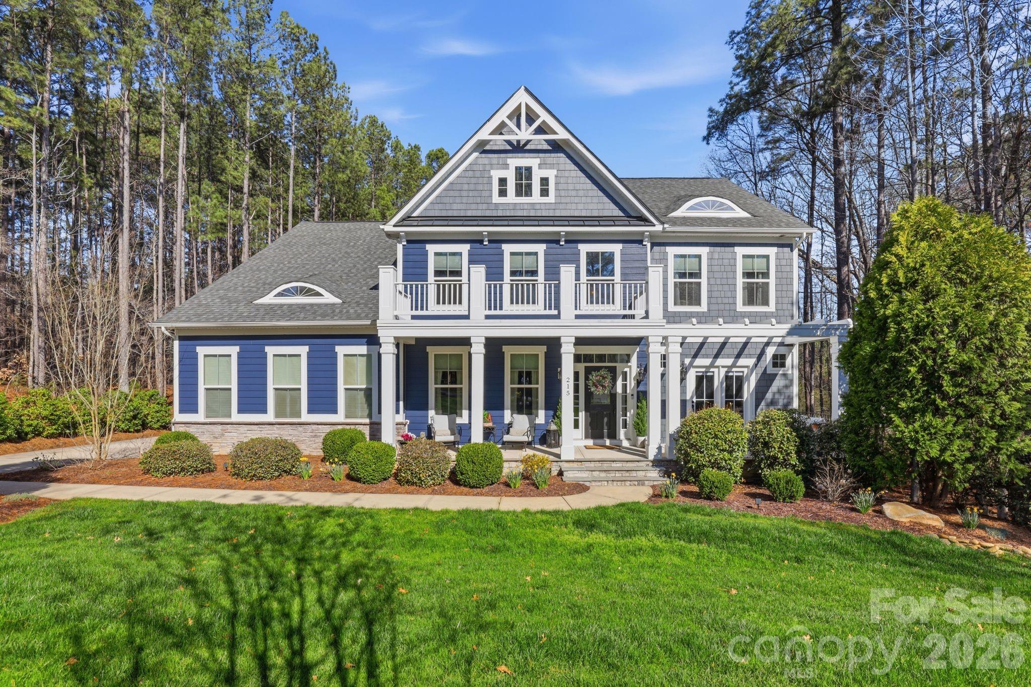 215 Streamwood Road Troutman, NC 28166 - Photo 1 of 48 a front view of a house with swimming pool and porch
