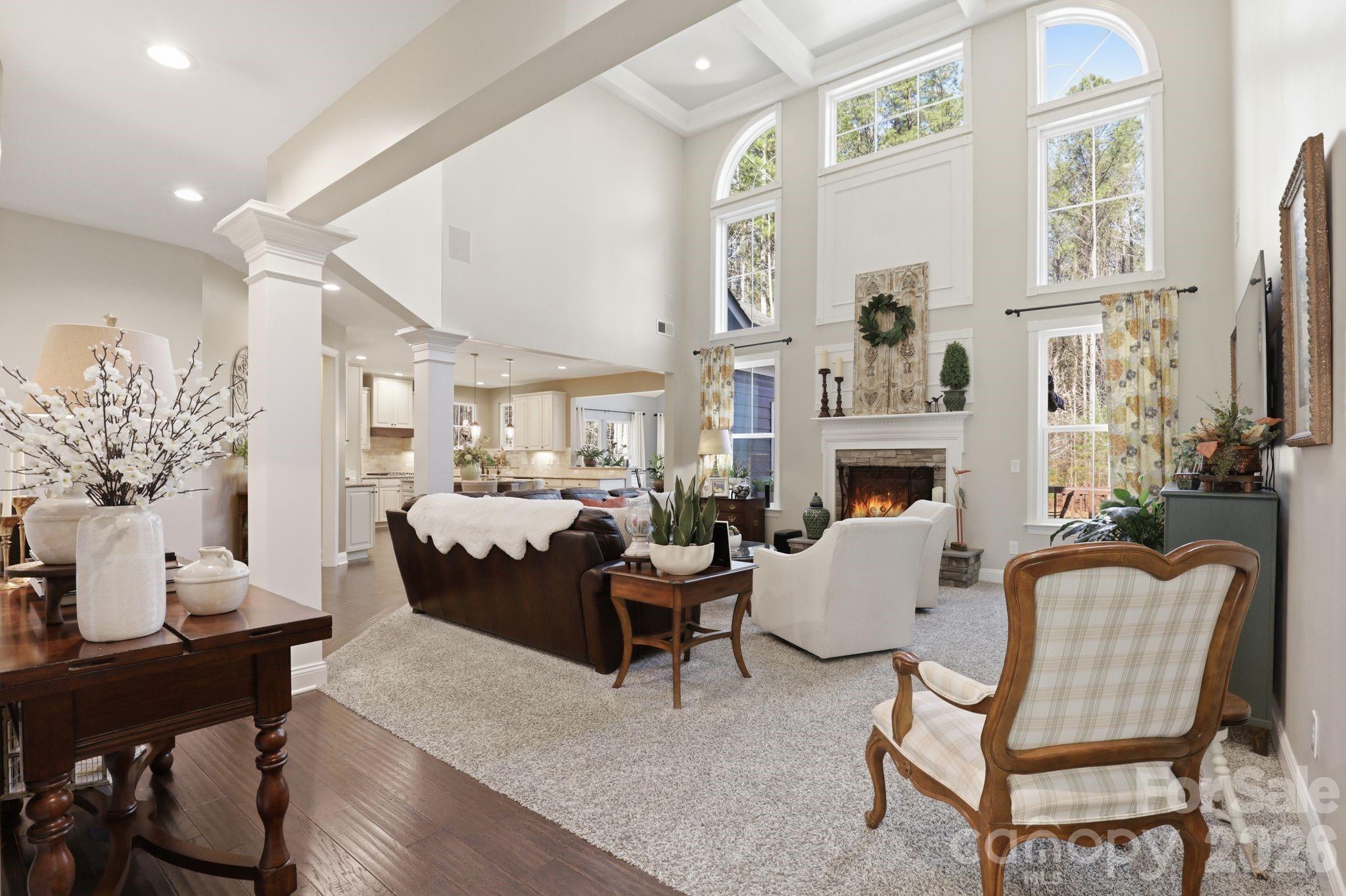 215 Streamwood Road Troutman, NC 28166 - Photo 13 of 48 a living room with furniture a fireplace and a table