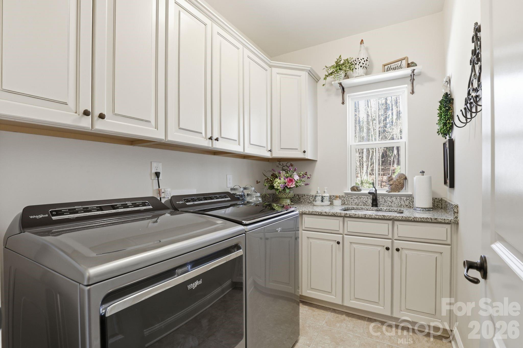 215 Streamwood Road Troutman, NC 28166 - Photo 16 of 48 a kitchen with granite countertop white cabinets and white appliances