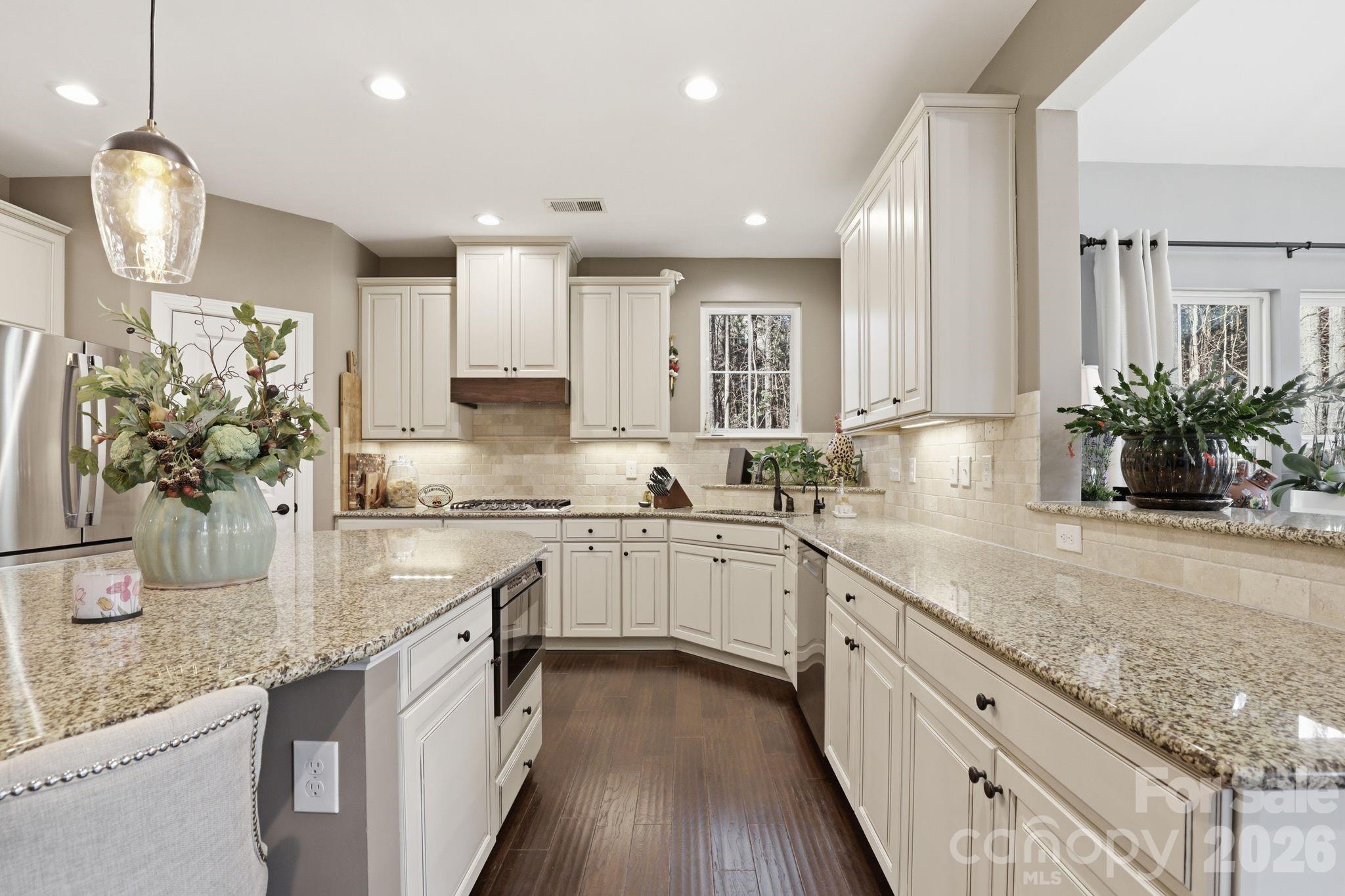 215 Streamwood Road Troutman, NC 28166 - Photo 18 of 48 a kitchen with stainless steel appliances granite countertop sink stove top oven and cabinets