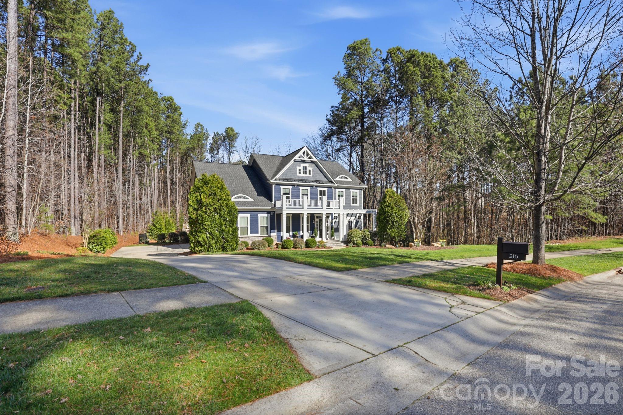 215 Streamwood Road Troutman, NC 28166 - Photo 2 of 48 a view of a house with a yard and large trees