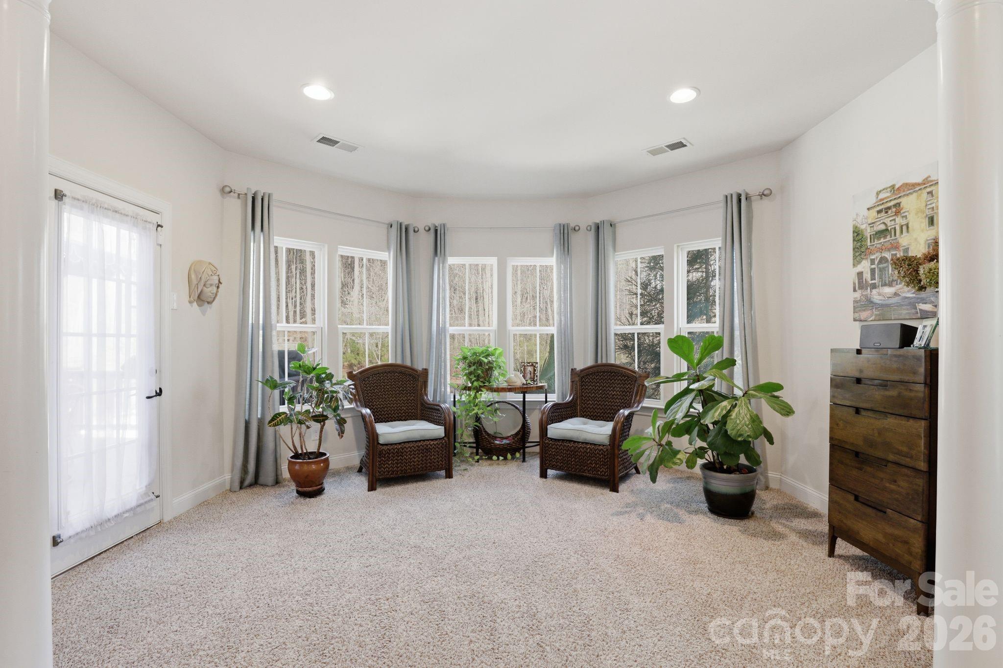 215 Streamwood Road Troutman, NC 28166 - Photo 22 of 48 a living room with furniture potted plant and windows