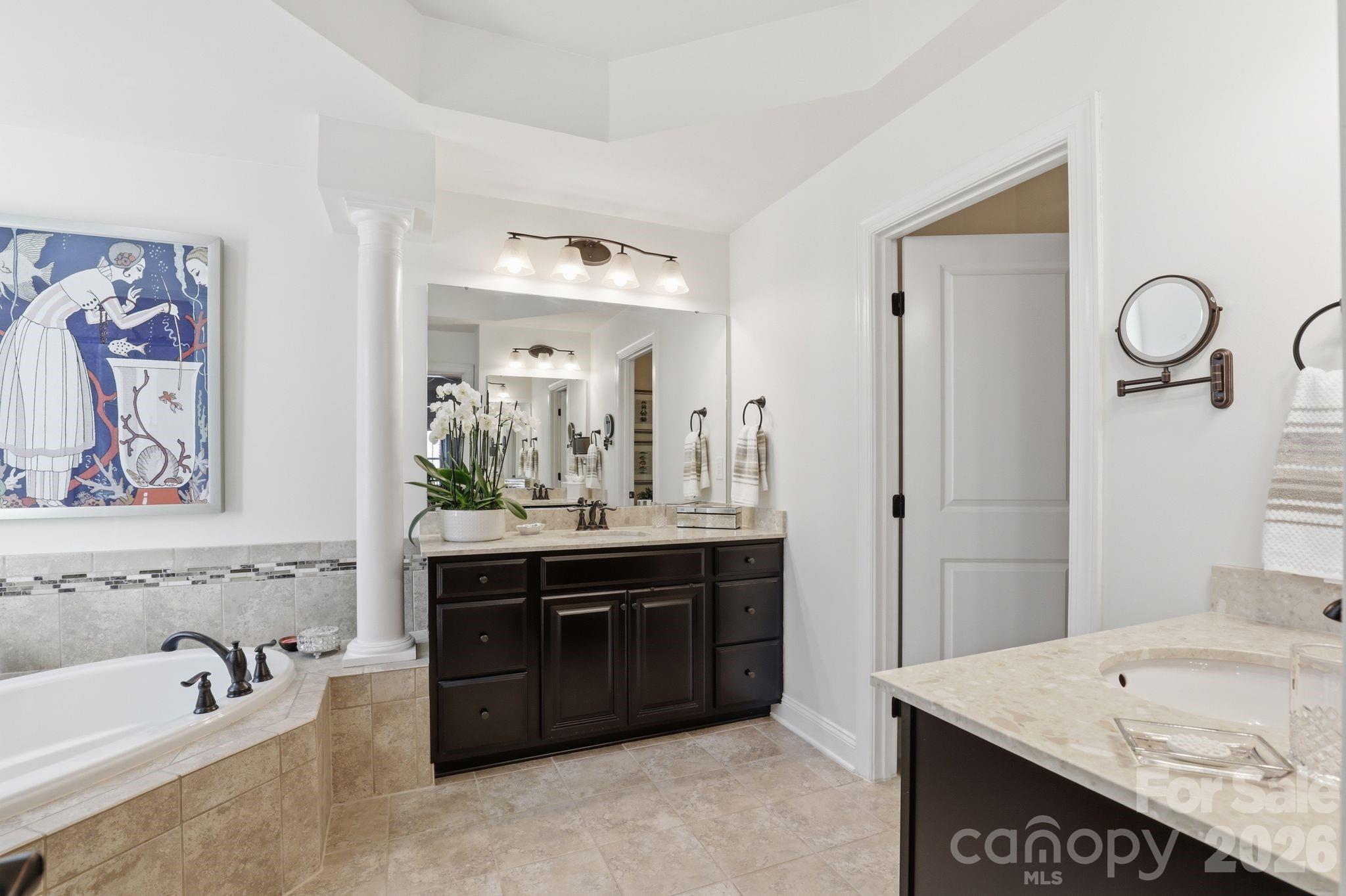 215 Streamwood Road Troutman, NC 28166 - Photo 26 of 48 a spacious bathroom with a tub a double vanity sink and mirror