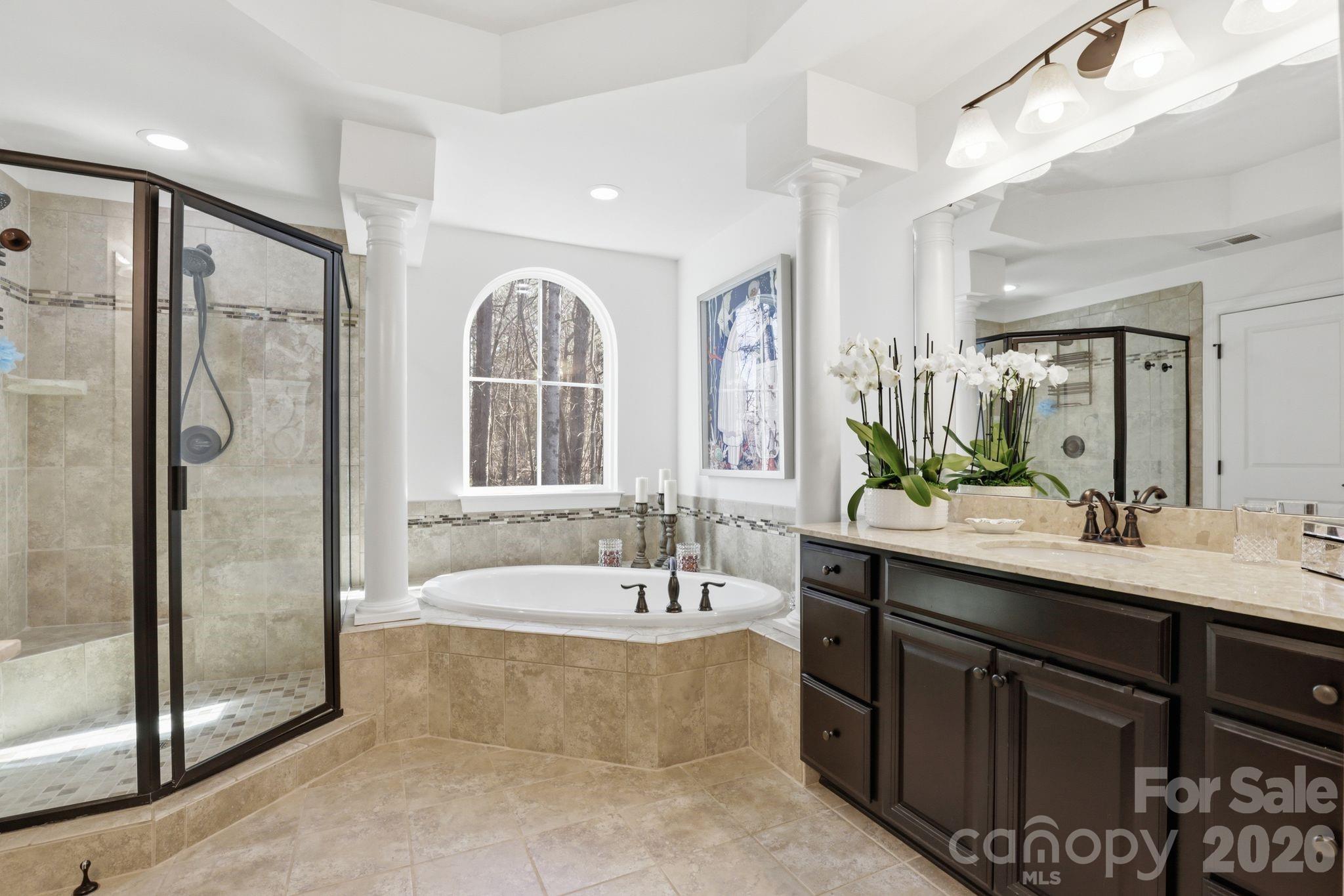 215 Streamwood Road Troutman, NC 28166 - Photo 27 of 48 a bathroom with a tub sink shower and mirror