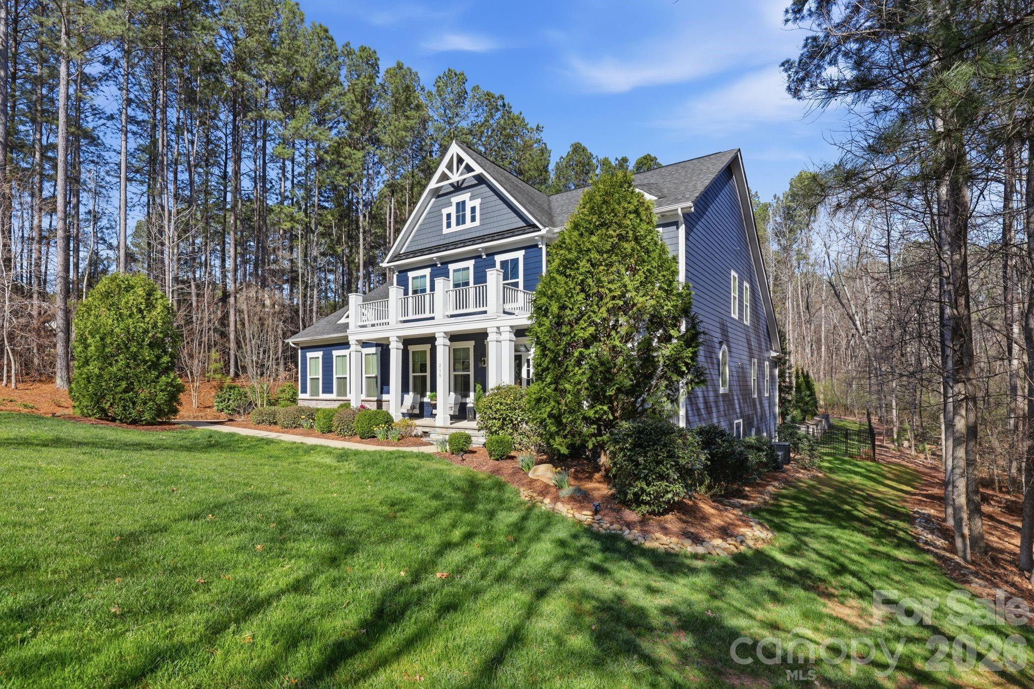 215 Streamwood Road Troutman, NC 28166 - Photo 3 of 48 a front view of a house with a garden