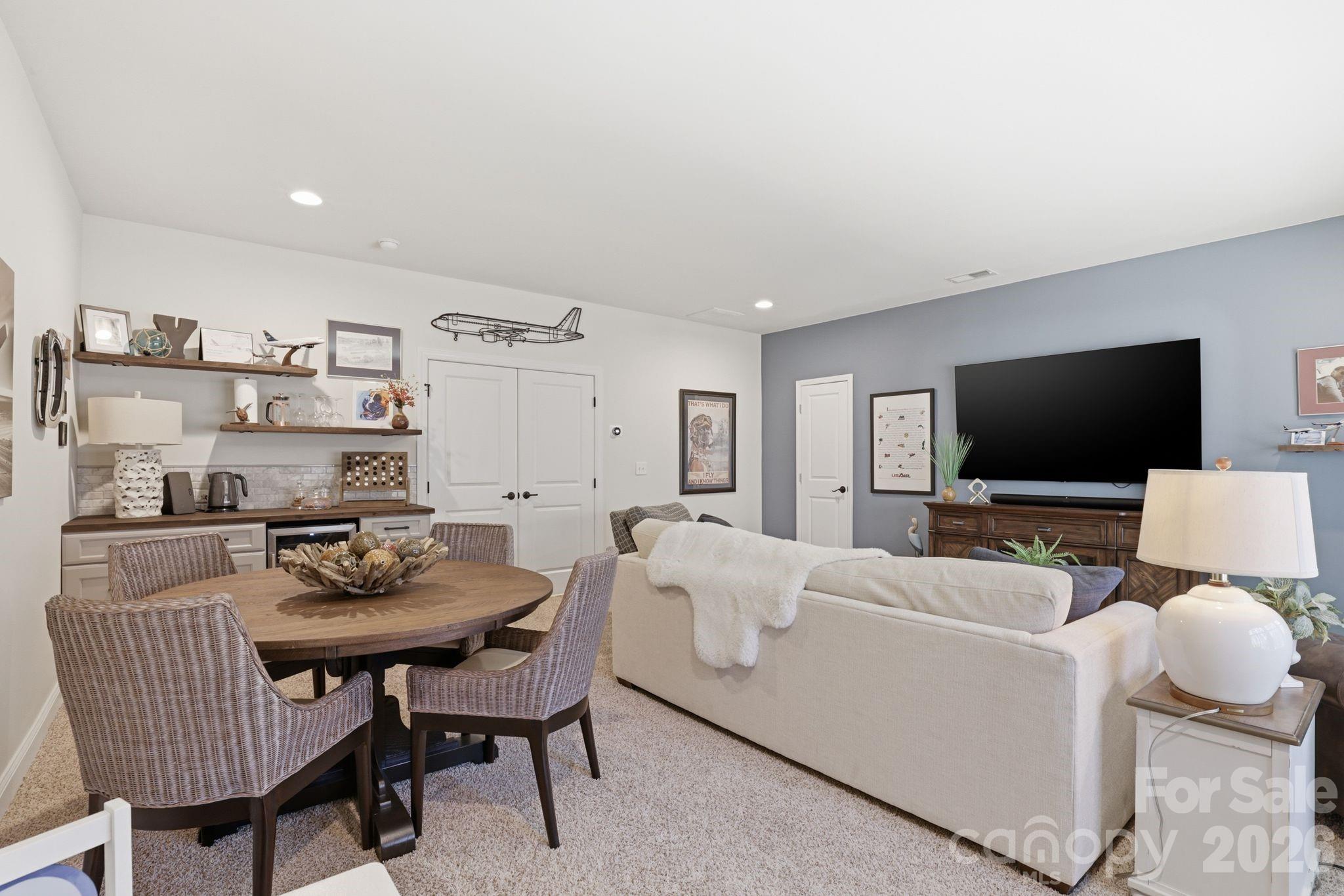 215 Streamwood Road Troutman, NC 28166 - Photo 31 of 48 a living room with furniture and a flat screen tv
