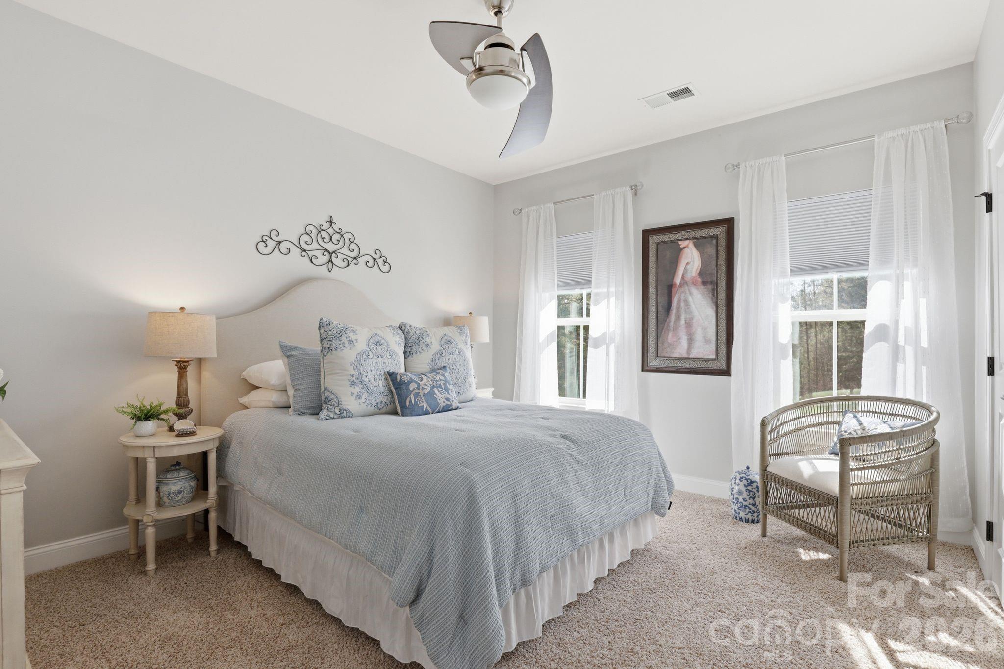 215 Streamwood Road Troutman, NC 28166 - Photo 35 of 48 a bedroom with a bed and wooden floor