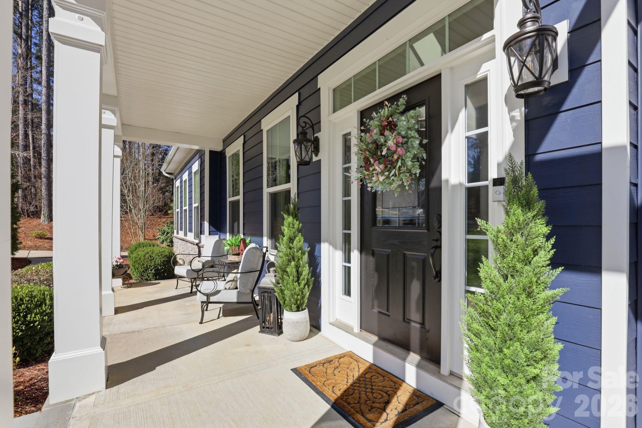 215 Streamwood Road Troutman, NC 28166 - Photo 4 of 48 a view of front door and porch with seating space