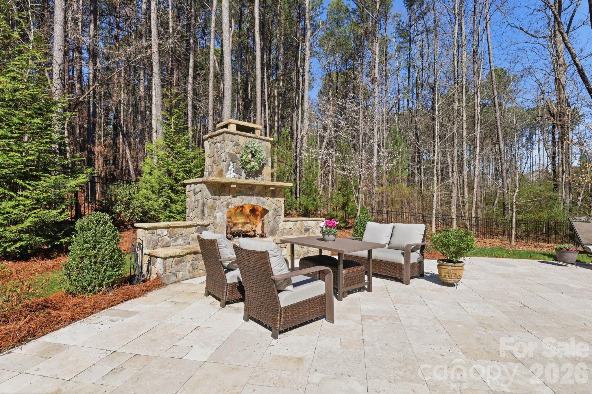 215 Streamwood Road Troutman, NC 28166 - Photo 42 of 48 a view of a patio with couches and table and chairs with wooden fence