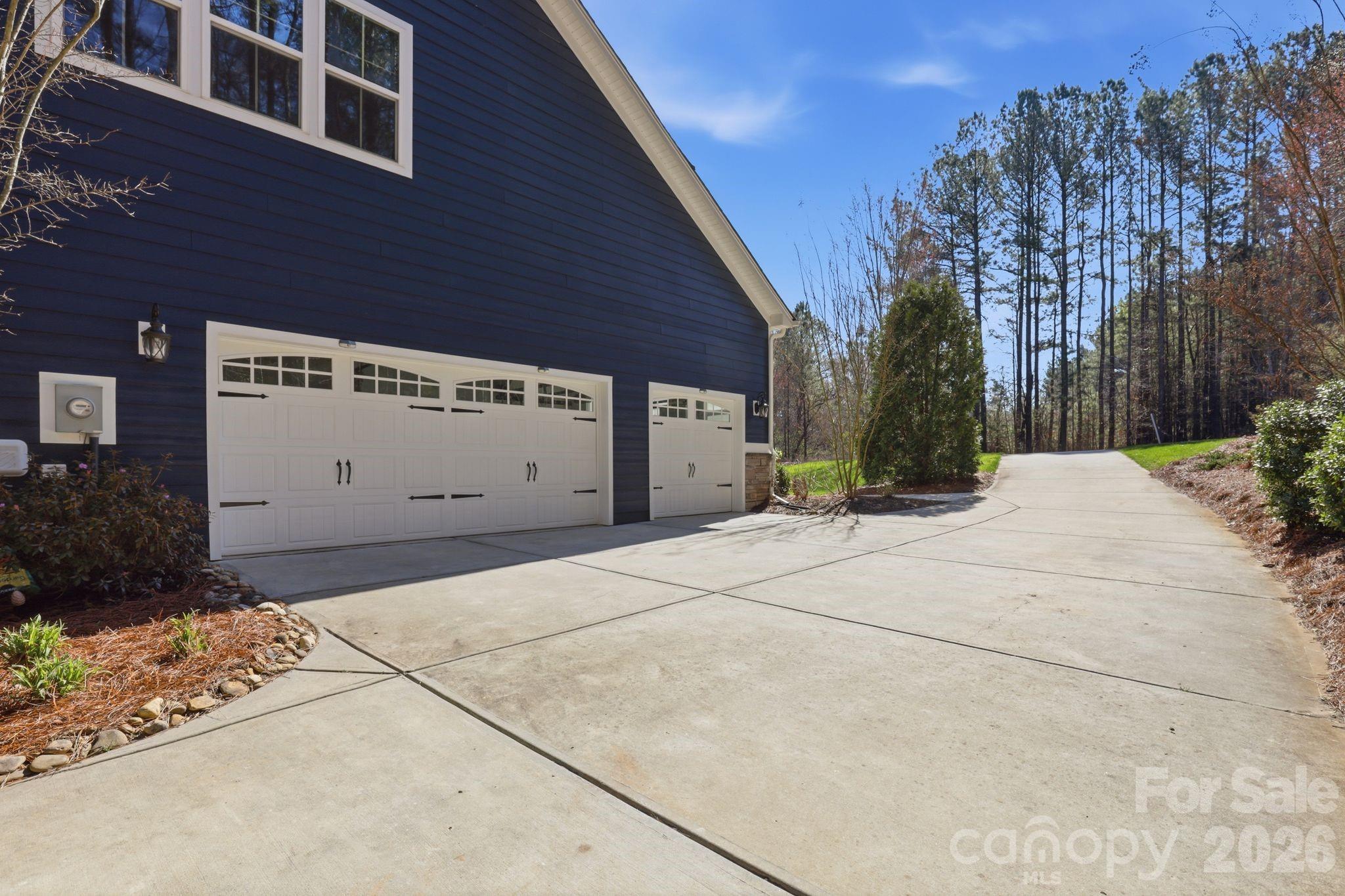 215 Streamwood Road Troutman, NC 28166 - Photo 44 of 48 a view of a white house with a large space in front of it