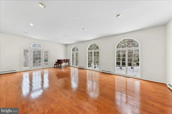 a view of empty room with wooden floor and fireplace