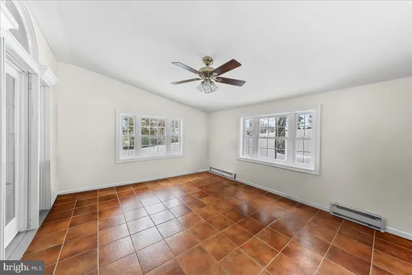 a large kitchen with kitchen island a large counter top space a sink stainless steel appliances and cabinets