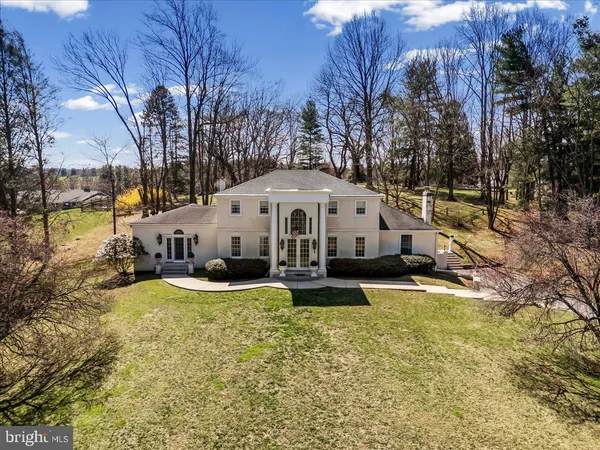 a view of a house with swimming pool and sitting area
