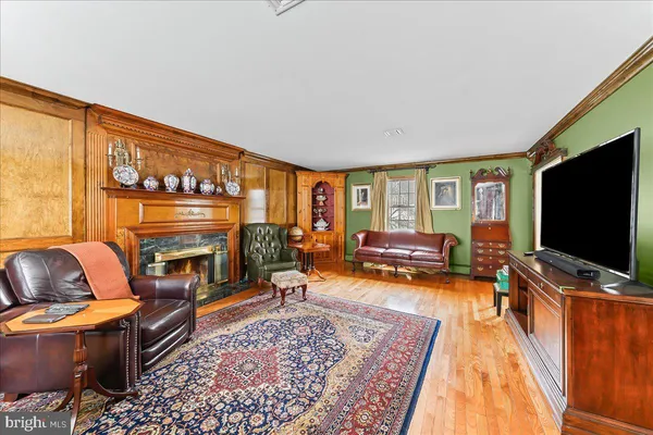 a bedroom with a bed and large windows