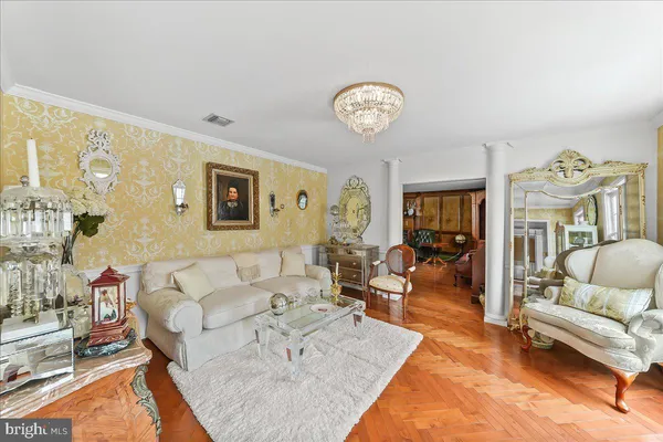a dining room with furniture a rug and a chandelier