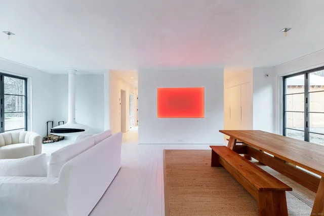 a room with furniture pool table and windows