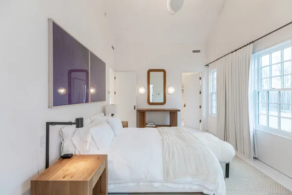 a view of room with mirror and window