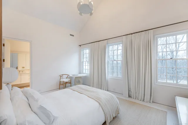 a bedroom with a large bed and a window