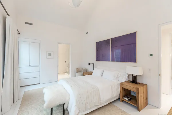 a bedroom with a bed and a chair