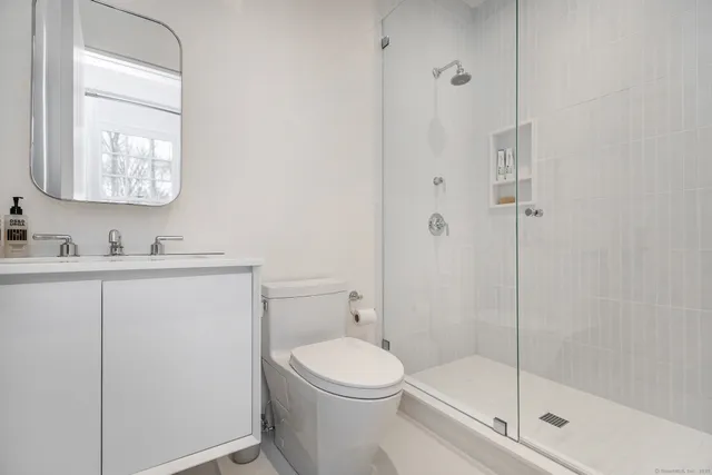 a bathroom with a toilet a sink and shower