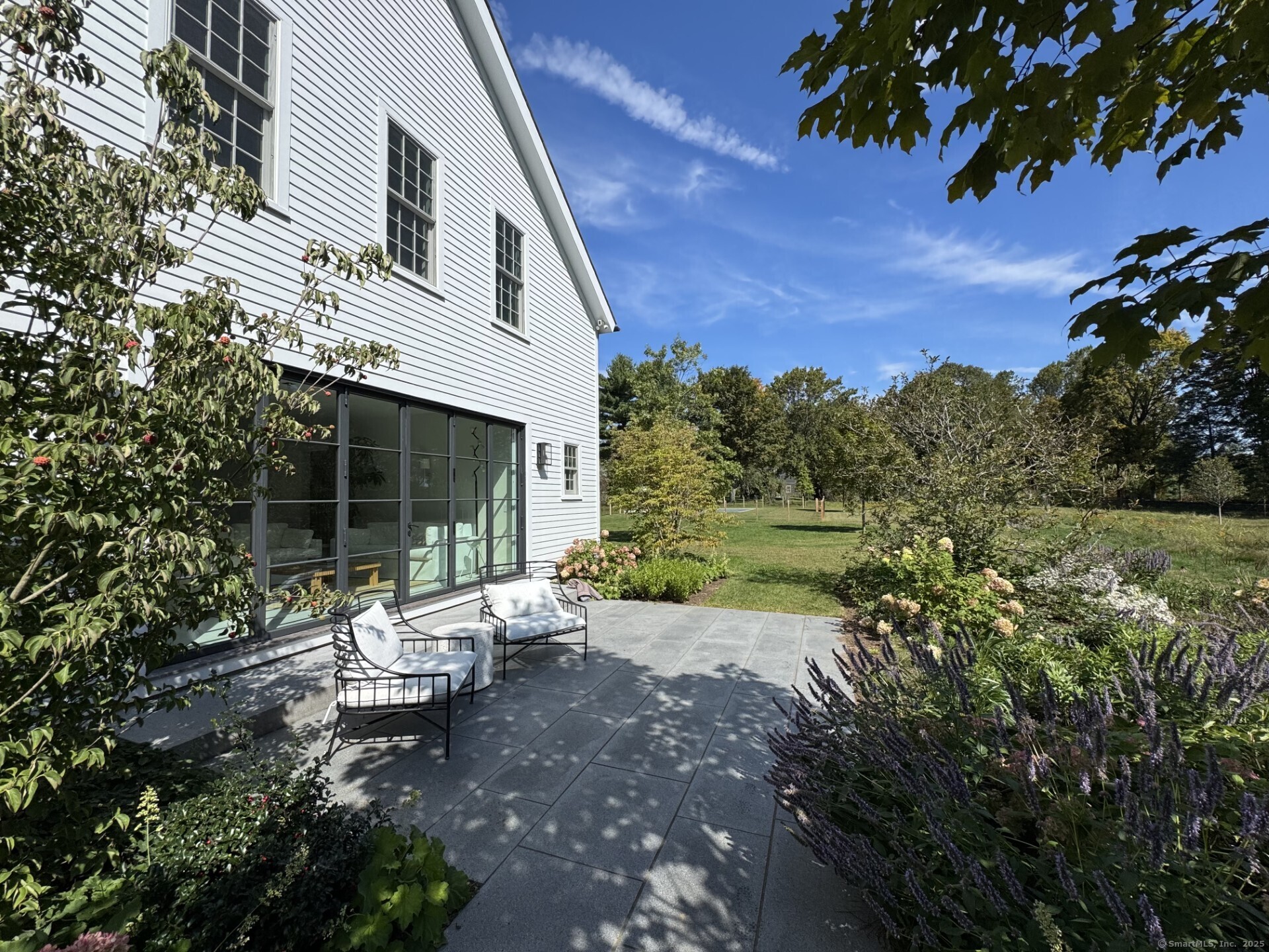 24 Old Roxbury Road Roxbury, CT 06783 - Photo 36 of 38 a view of a patio with chair and table and chairs under an umbrella