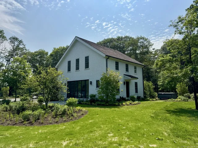 a front view of house with yard and green space