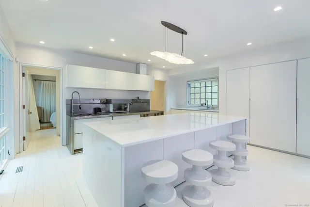a large kitchen with a table and chairs