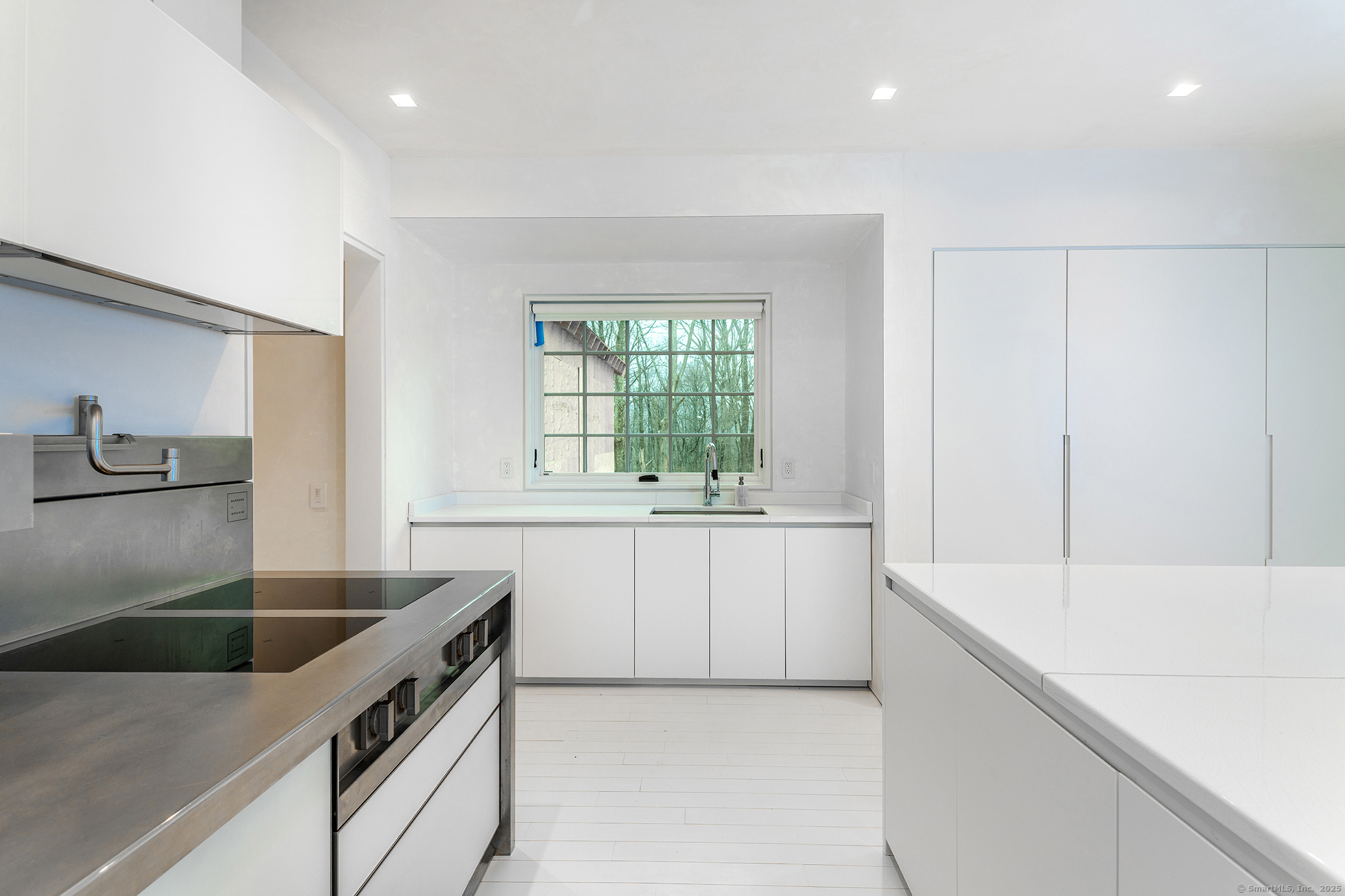 24 Old Roxbury Road Roxbury, CT 06783 - Photo 8 of 38 a kitchen with a sink dishwasher a stove and white cabinets with wooden floor