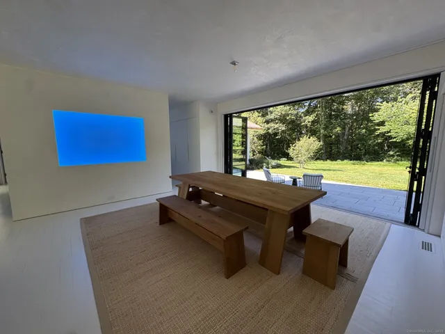 a room with pool table and windows