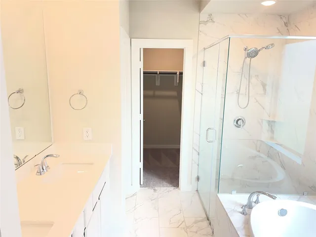 a bathroom with a shower and a sink