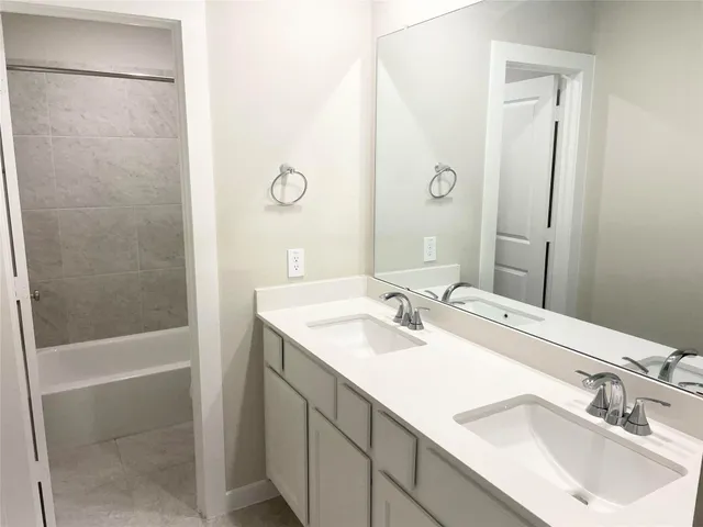 a bath tub sitting next to a white toilet and a shower