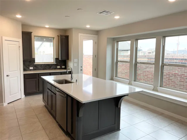 a kitchen with a sink stove and cabinets