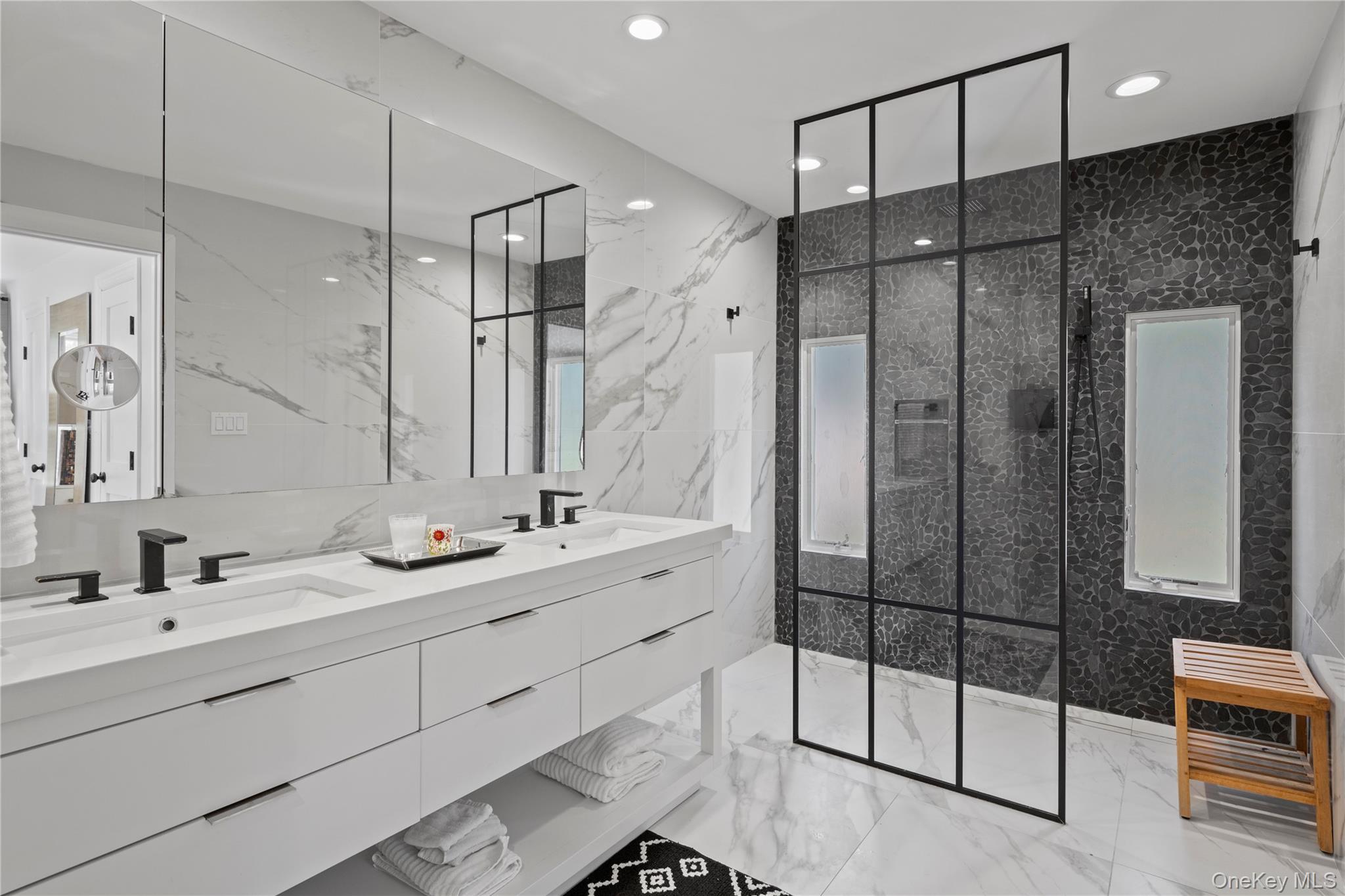 38 Pheasant Run Quogue, NY 11959 - Photo 18 of 35 a bathroom with a double vanity sink mirror and shower