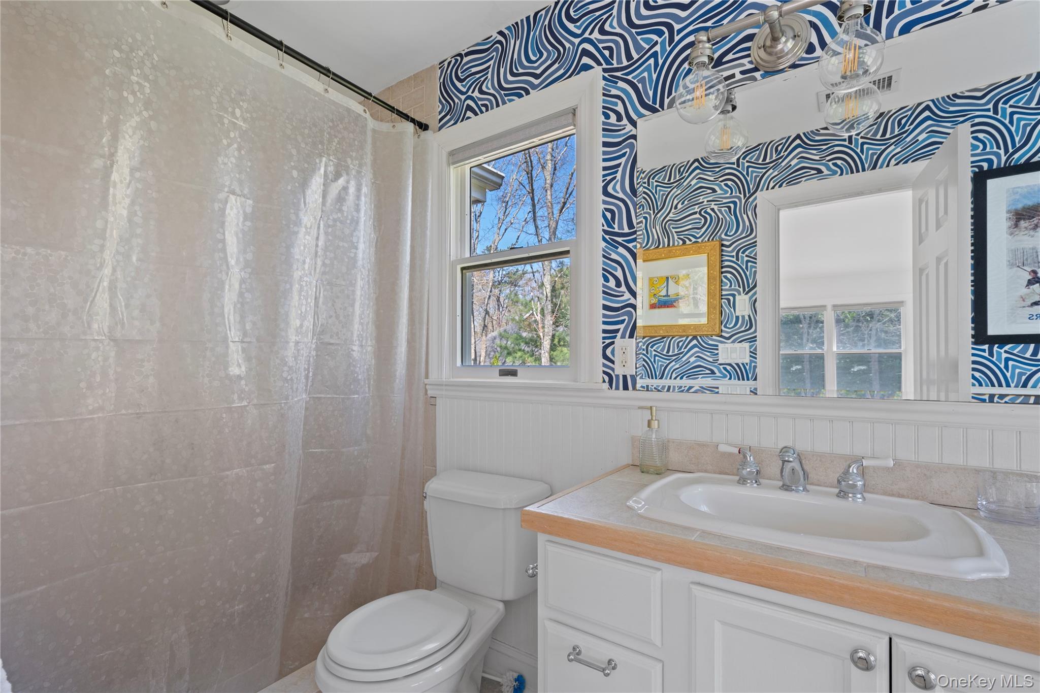 38 Pheasant Run Quogue, NY 11959 - Photo 20 of 35 a bathroom with a granite countertop sink a toilet and a mirror