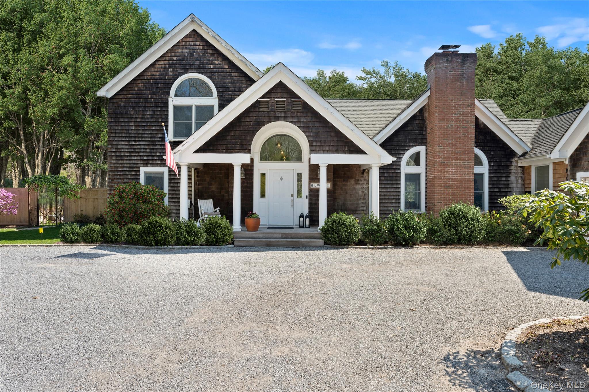38 Pheasant Run Quogue, NY 11959 - Photo 2 of 35 a front view of a house with a garden