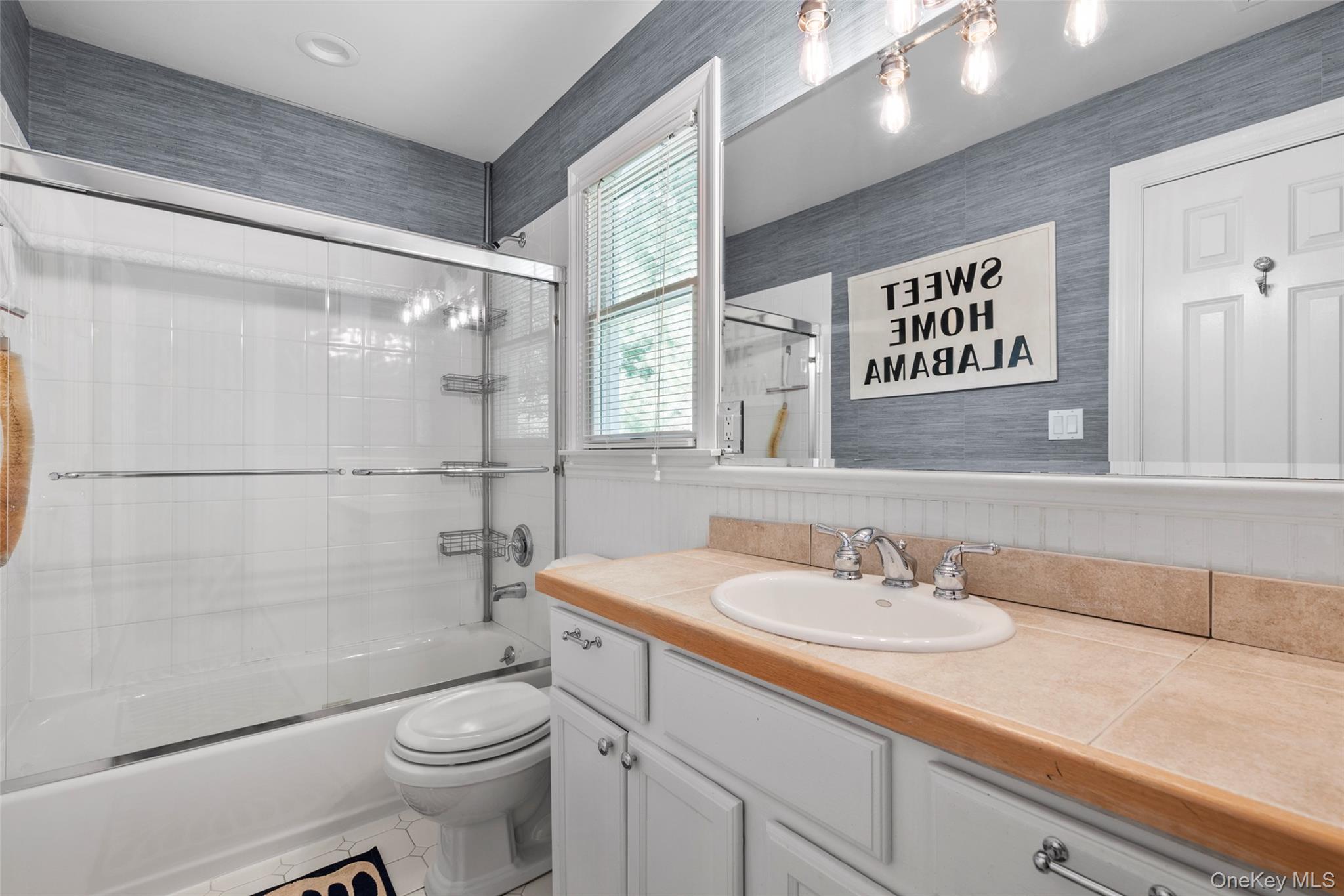 38 Pheasant Run Quogue, NY 11959 - Photo 22 of 35 a bathroom with a sink a toilet and shower