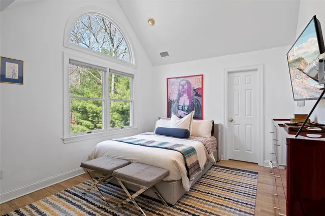 a bedroom with a bed and a window