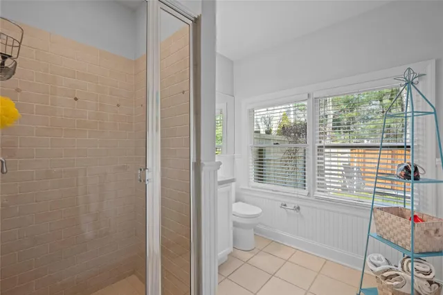 a bathroom with a toilet and a shower