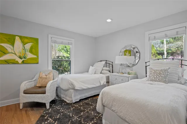 a bedroom with two beds and a window