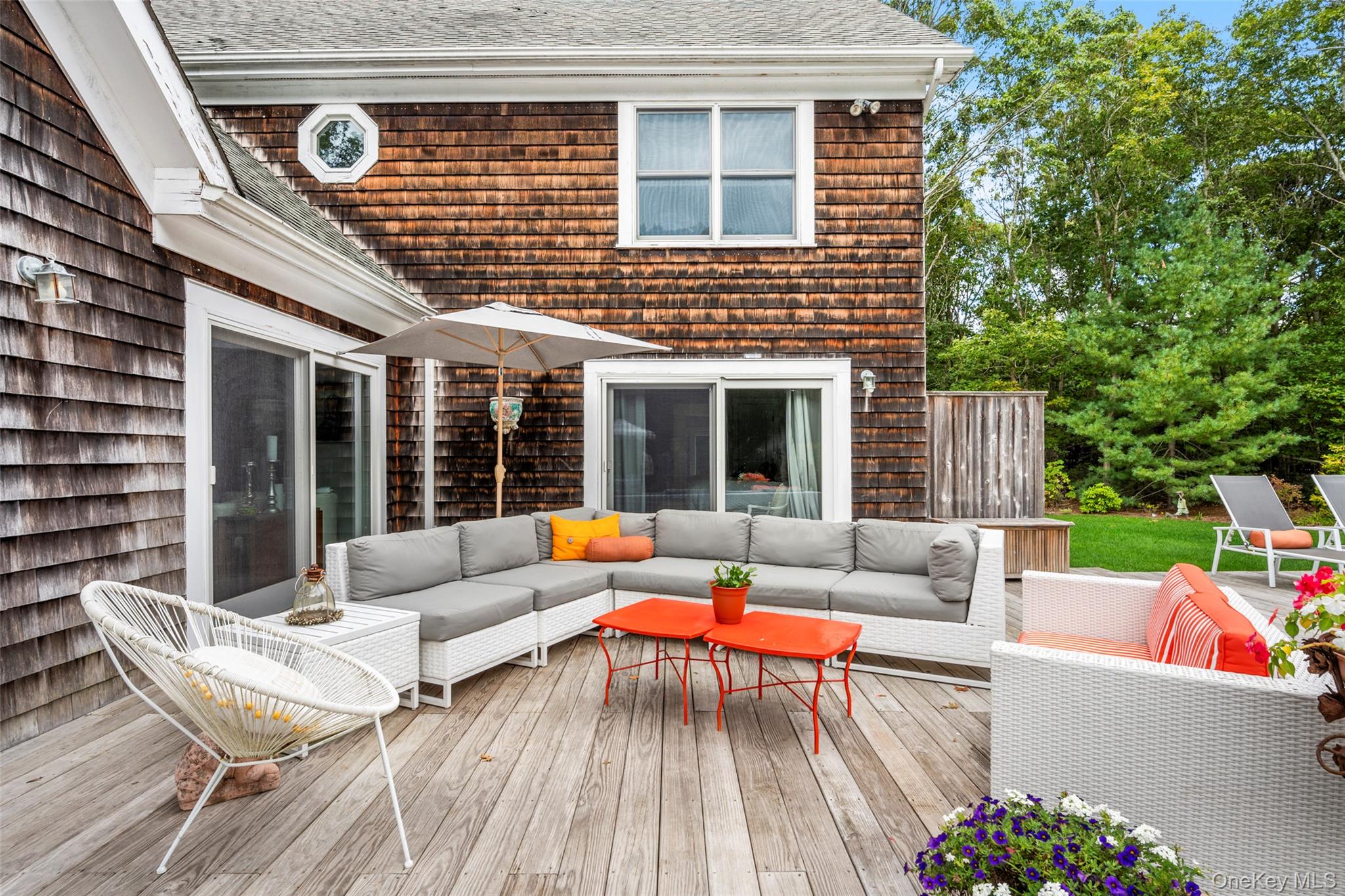 38 Pheasant Run Quogue, NY 11959 - Photo 29 of 35 a view of a patio with couches table and chairs and potted plants