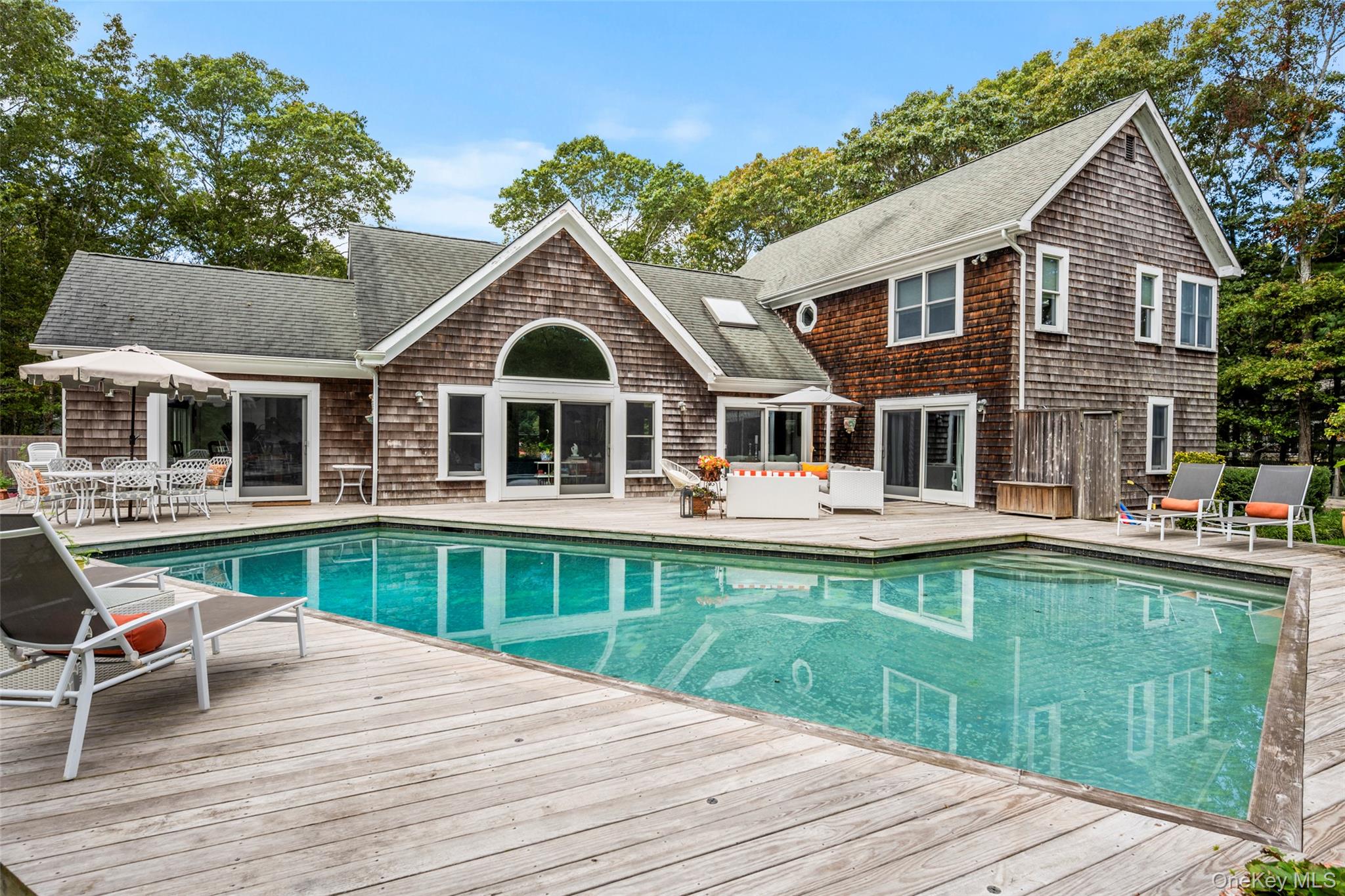 38 Pheasant Run Quogue, NY 11959 - Photo 3 of 35 a front view of a house with yard and ocean view